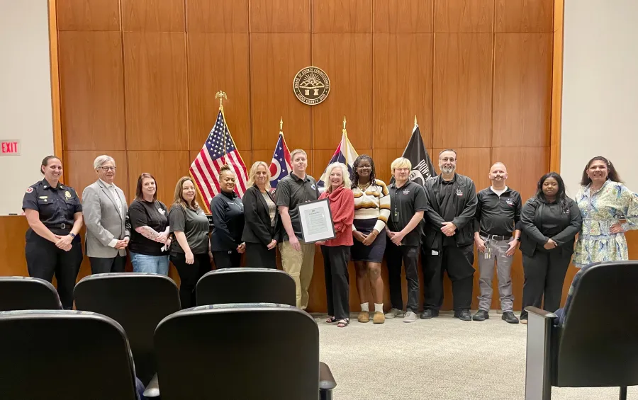 Lucas County 911 RCOG Management, Telecommunicators, and Union Leadership pause for a photo with the Lucas County Commissioners.